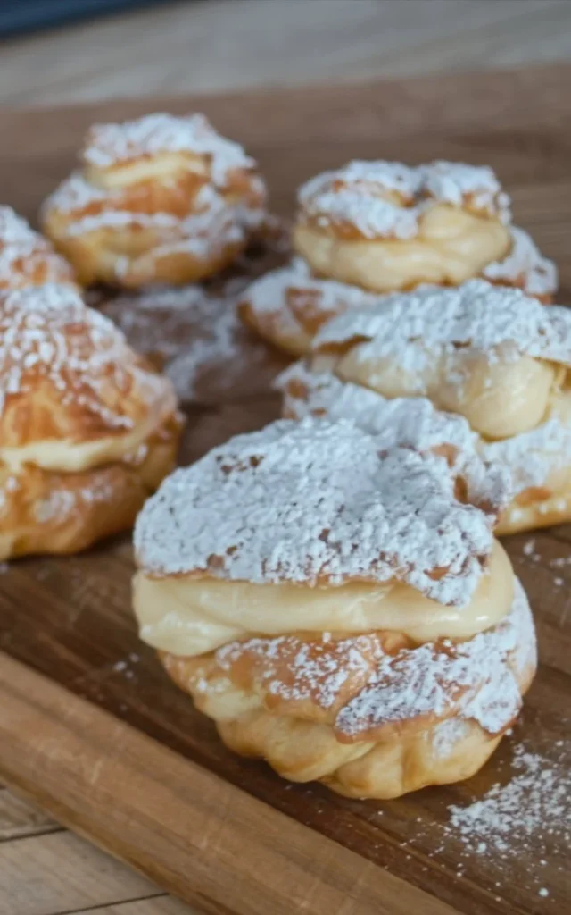 Easy cream puffs filled with whipped cream and topped with chocolate drizzle