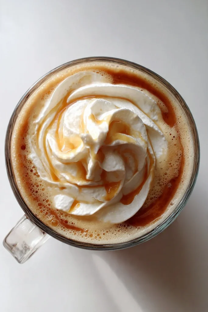Cup of maple syrup coffee surrounded by coffee beans and maple syrup