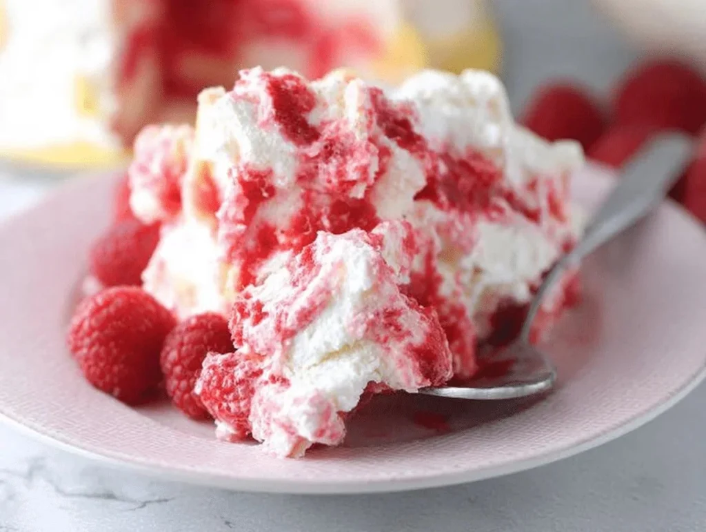 Delicious Raspberry Angel Food Cake topped with fresh raspberries