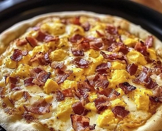 Delicious breakfast pizza topped with eggs, cheese, and vegetables.