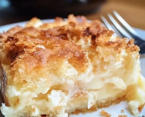 Delicious coconut cheesecake bread pudding served with a creamy topping