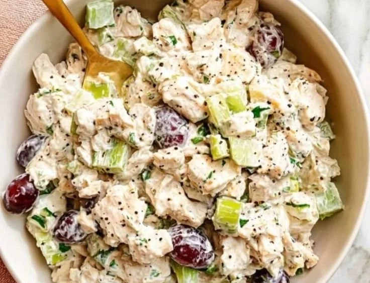 Healthy chicken salad with grapes and almonds served in a bowl