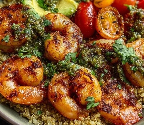 Healthy grilled shrimp quinoa bowl with fresh vegetables and herbs