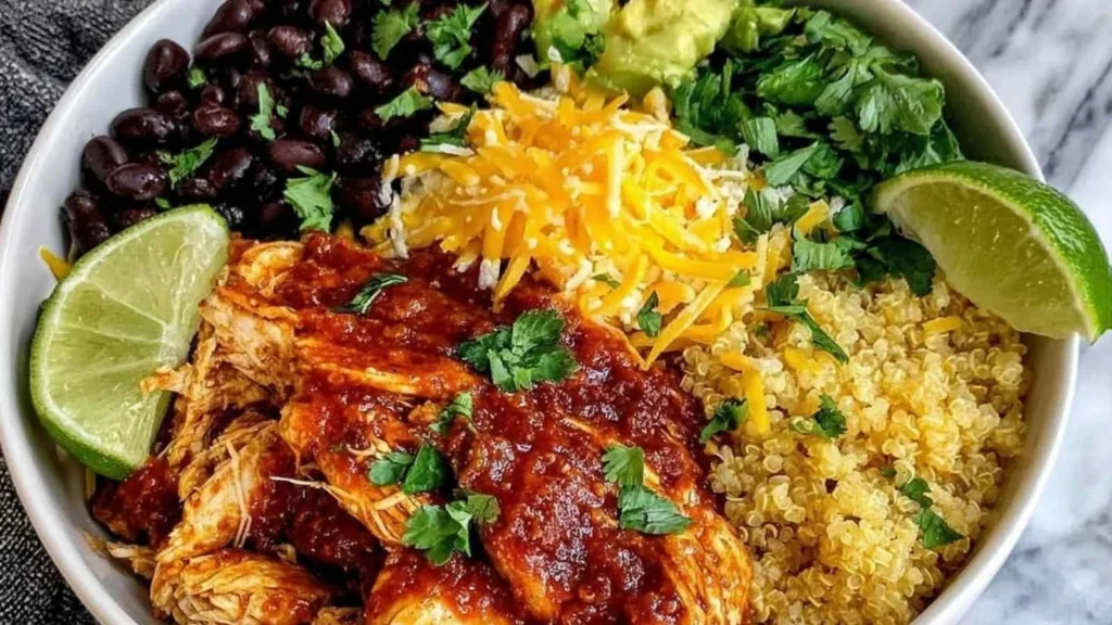 High protein chicken enchilada bowl topped with fresh ingredients and cheese