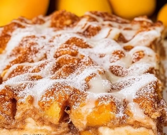 Bowl of freshly baked Peach Bread Pudding with golden peaches and warm custard.