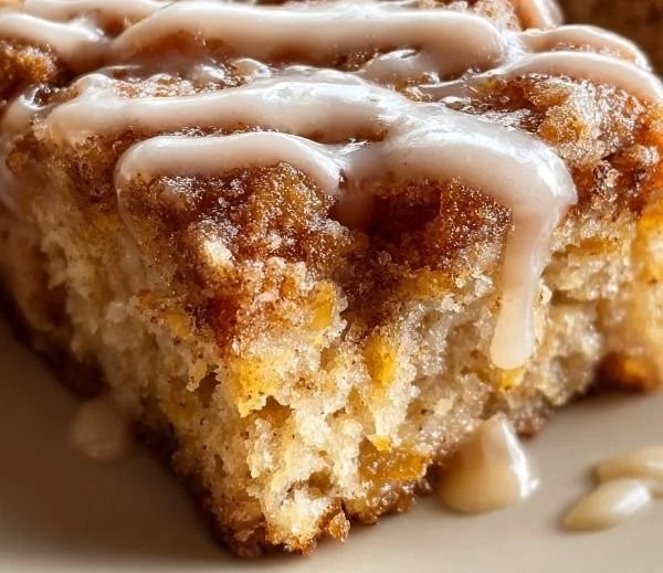 Soft baked maple donut bars on a plate with maple glaze and sprinkles