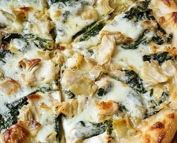 Delicious spinach artichoke pizza with fresh toppings and creamy sauce
