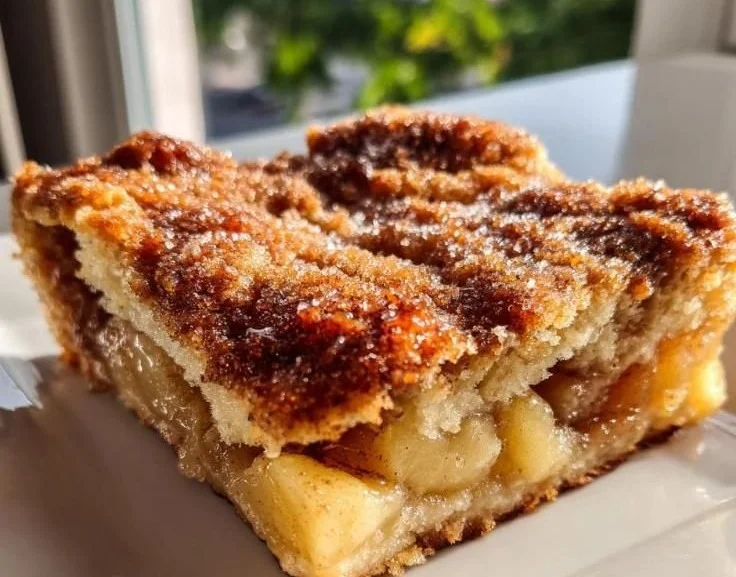 Delicious homemade apple cobbler with a golden topping and fresh apples