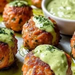 Baked salmon meatballs with creamy avocado sauce on a plate