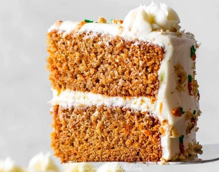 Delicious slice of the best carrot cake topped with cream cheese frosting