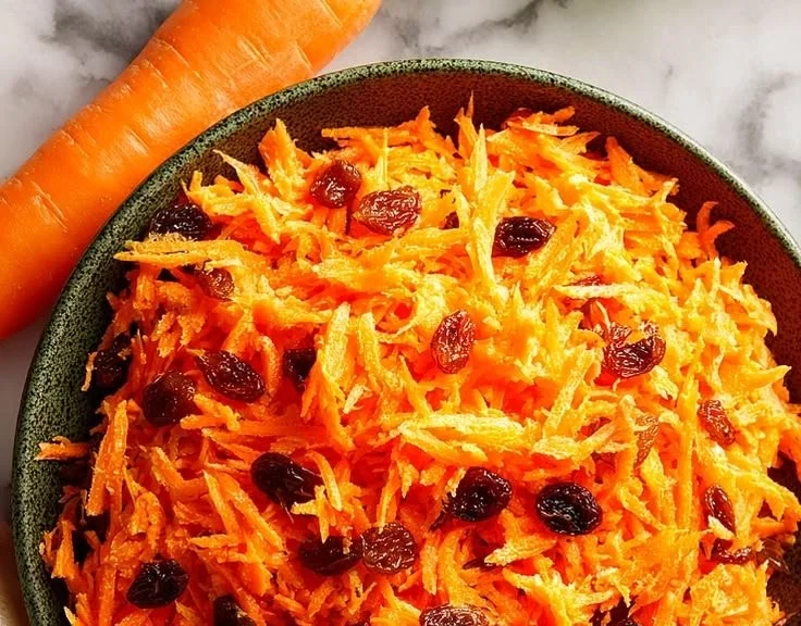 Delicious carrot raisin salad with bright orange carrots and sweet raisins