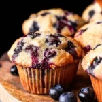 Freshly baked blueberry muffins on a cooling rack