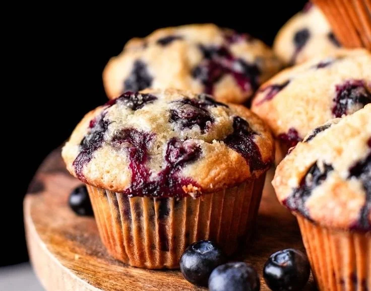 Freshly baked blueberry muffins on a cooling rack