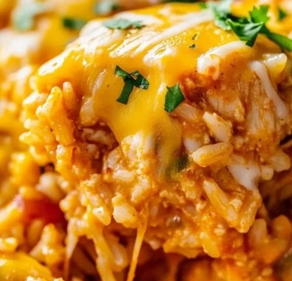 Delicious Chicken Enchilada Rice Casserole topped with cheese and garnished with cilantro