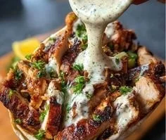 Plate of Chicken Shawarma drizzled with garlic sauce