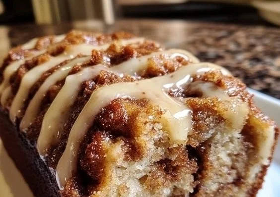 Delicious cinnamon roll banana bread, fresh out of the oven with cinnamon swirls.