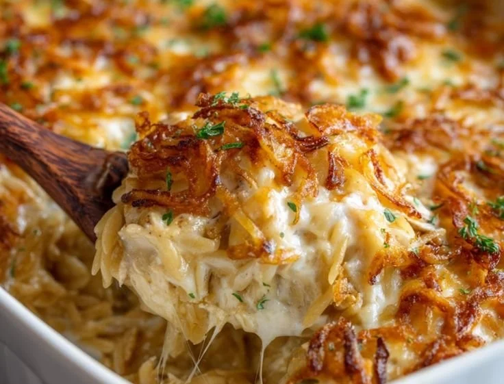 Delicious French Onion Chicken Orzo Casserole topped with crispy cheese and herbs.