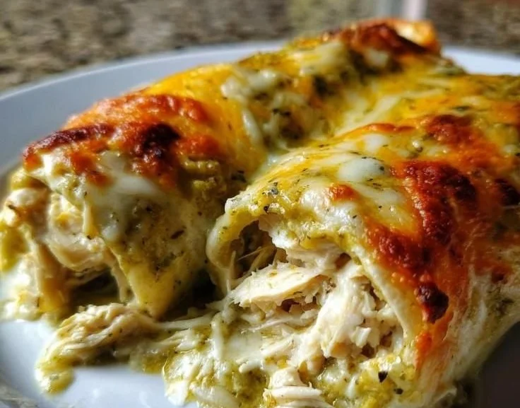 Delicious Green Chile Chicken Enchiladas topped with cheese and green chiles