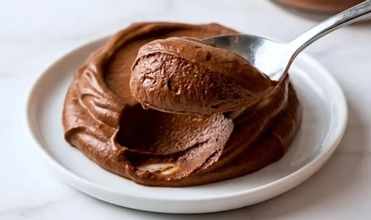 High protein chocolate mousse served in a dessert cup with chocolate shavings