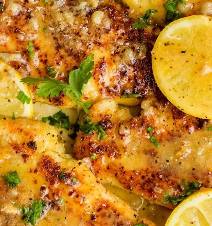 Deliciously cooked lemon chicken garnished with fresh herbs
