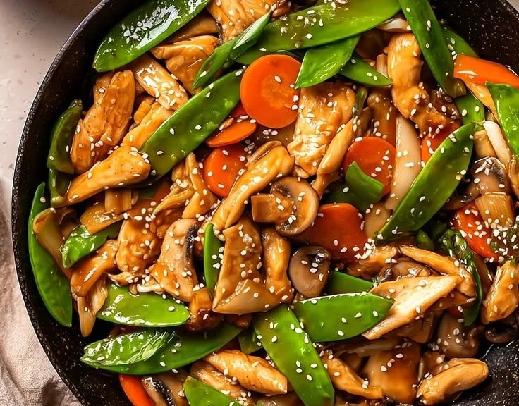 Mushroom Chicken casserole topped with cheese and fresh herbs