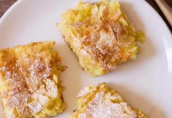 Delicious ooey gooey butter cake slice with a rich, buttery texture.