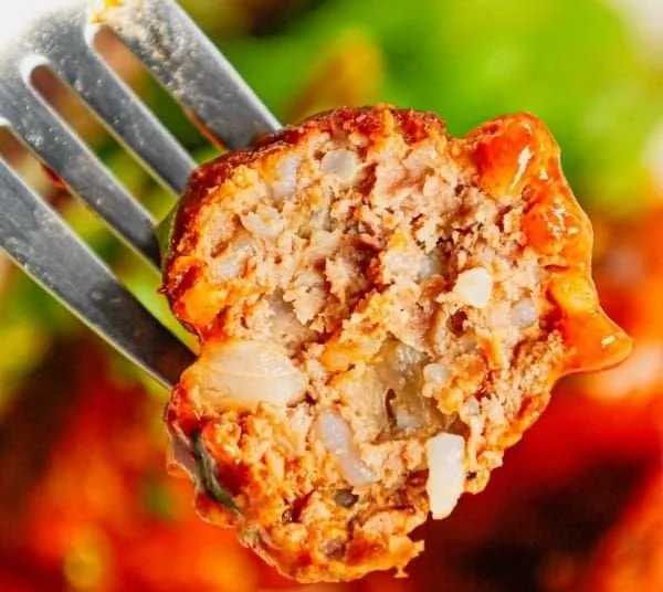 Delicious porcupine meatballs served on a plate with herbs.