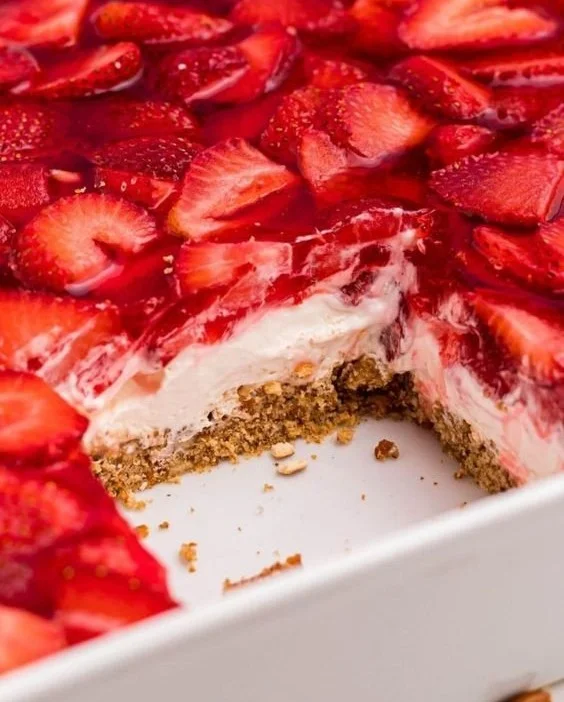 Delicious Strawberry Pretzel Salad topped with fresh strawberries and cream cheese