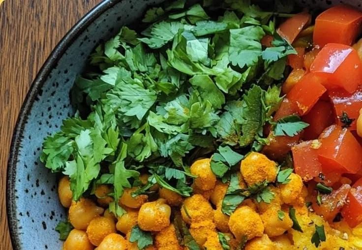 Turmeric Chickpea Rice Bowl topped with fresh herbs and spices