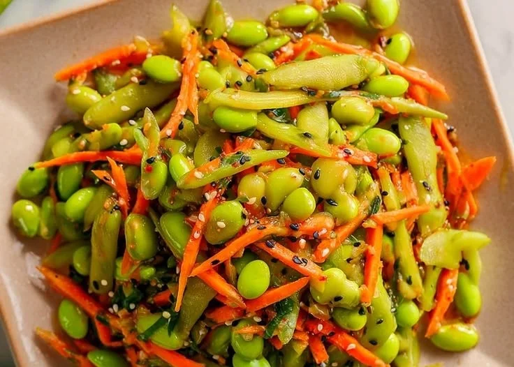 Vegan snap pea and edamame salad topped with fresh ingredients