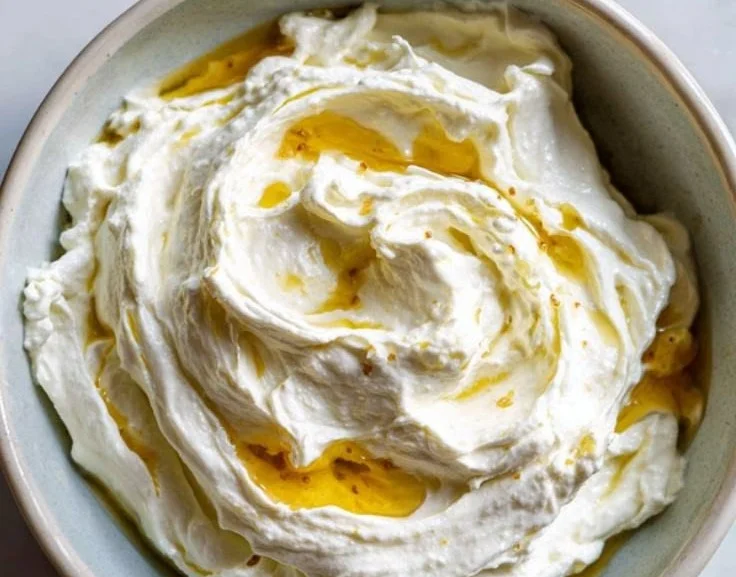 A bowl of creamy whipped feta dip with herbs and pita chips