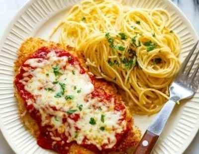 Delicious Air Fryer Chicken Parmesan served on a plate with marinara sauce and cheese