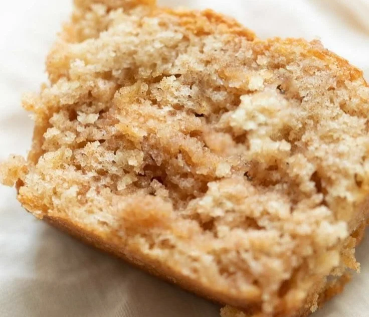 Loaf of freshly baked apple cinnamon bread with slices cut on a wooden board
