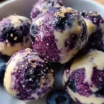 Blueberry cheesecake protein bites on a plate, healthy dessert option.