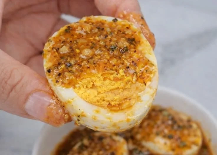 Spicy Cajun boiled eggs seasoned to perfection on a plate.