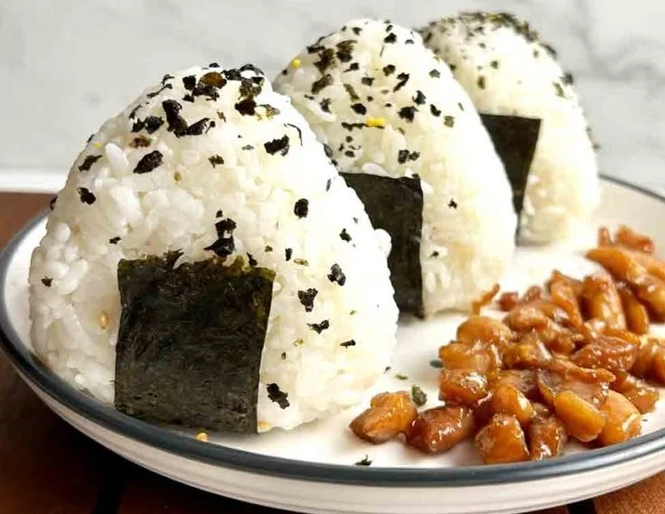 Delicious Chicken Rice Ball served with chili sauce and garnishes.