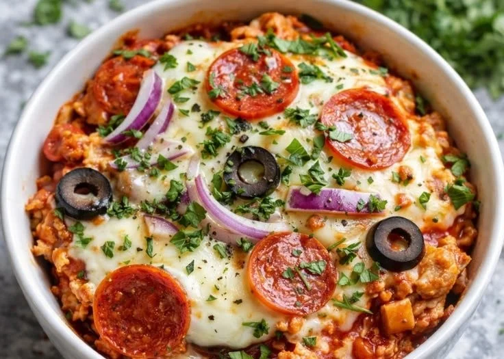 Cottage cheese pizza bowl topped with fresh vegetables and herbs