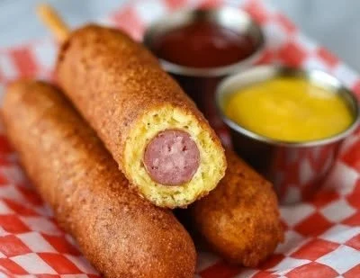 Crispy homemade corn dogs served with dipping sauce