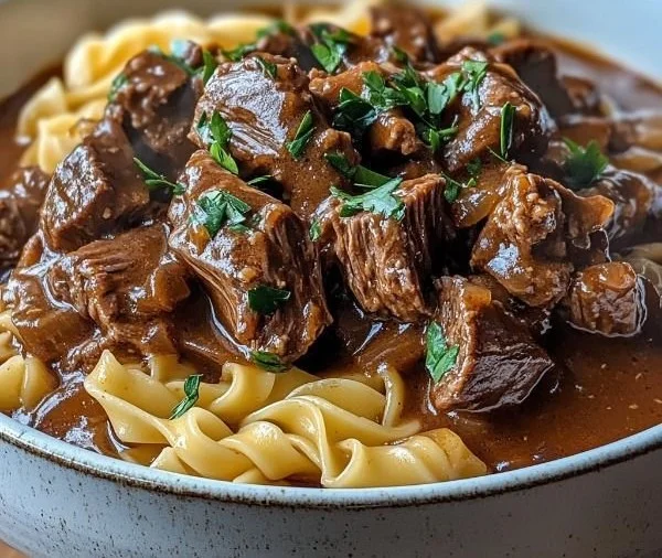 Crockpot Beef and Noodles dish served in a bowl with herbs