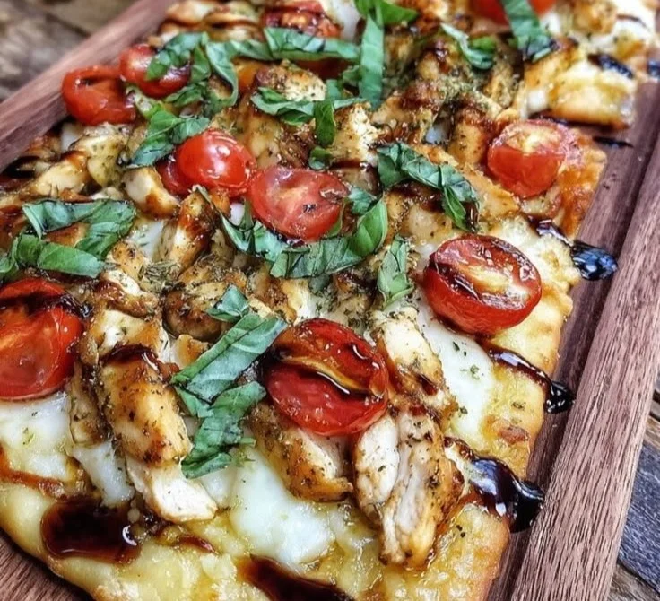 Easy Chicken Caprese Flatbread topped with fresh basil and mozzarella.