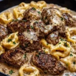 Delicious garlic steak pasta dish topped with fresh herbs and parmesan