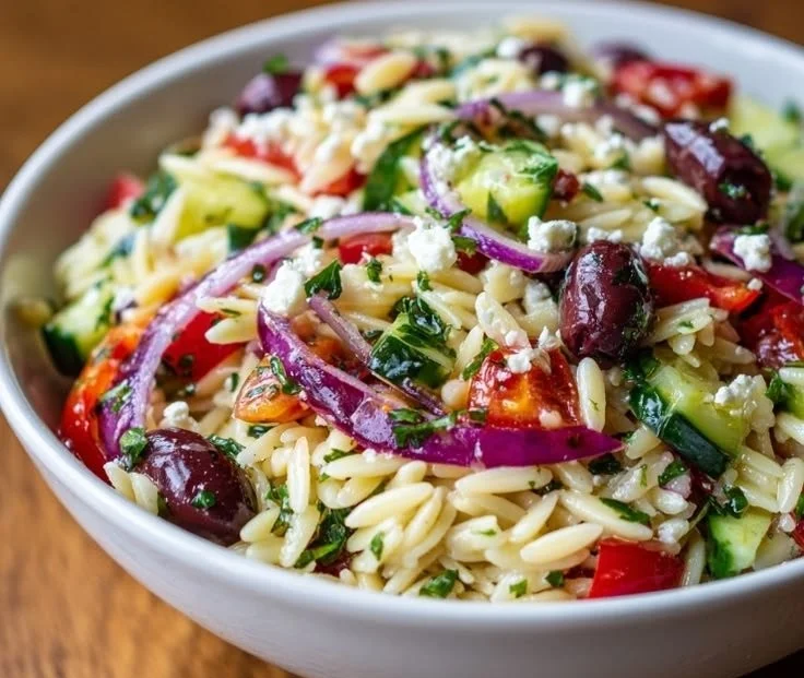 Colorful Greek Orzo Salad with fresh vegetables and feta cheese.