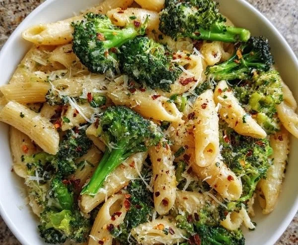 Healthy pasta dish featuring broccoli and vibrant vegetables.
