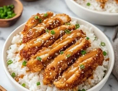 Crispy Chinese peanut butter chicken served with garnishes and chopsticks