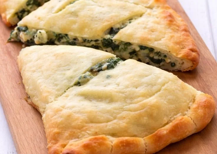 Keto Spinach Artichoke Pizza topped with fresh spinach and artichokes