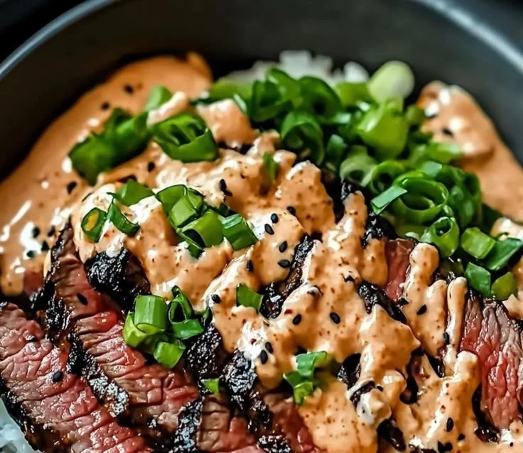 Korean BBQ steak rice bowl with spicy cream sauce and fresh vegetables
