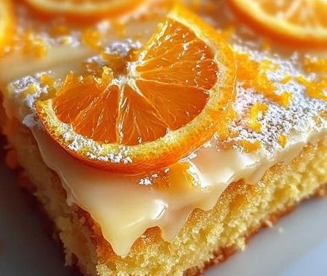 Moist orange sheet cake topped with orange frosting and zest