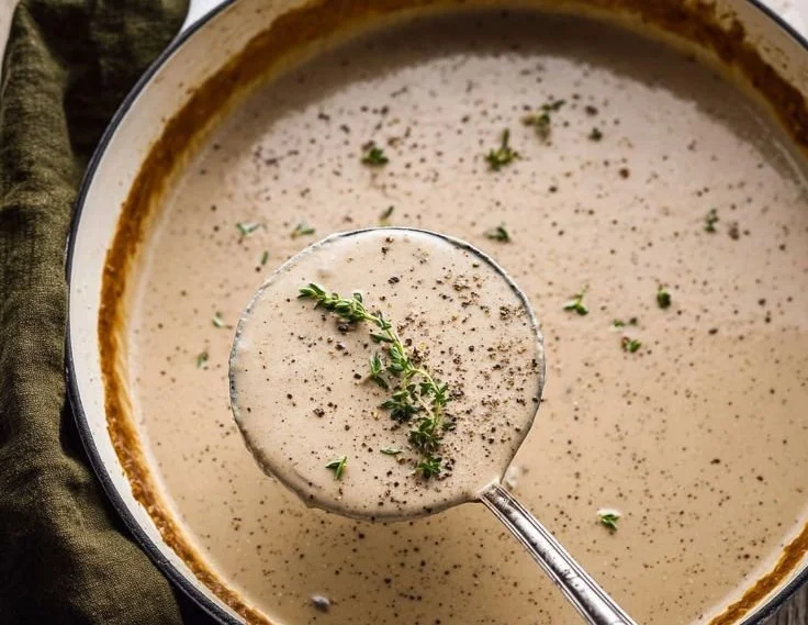 Creamy Mushroom Bisque garnished with herbs in a white bowl