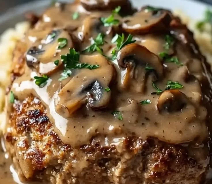 Delicious Mushroom-Gravy Meatloaf served with creamy mushroom sauce.