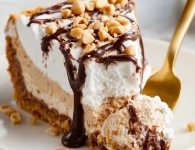 Delicious no-bake peanut butter pie topped with whipped cream and chocolate drizzle